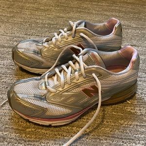 Shoes are grey and silver with hints of pink.